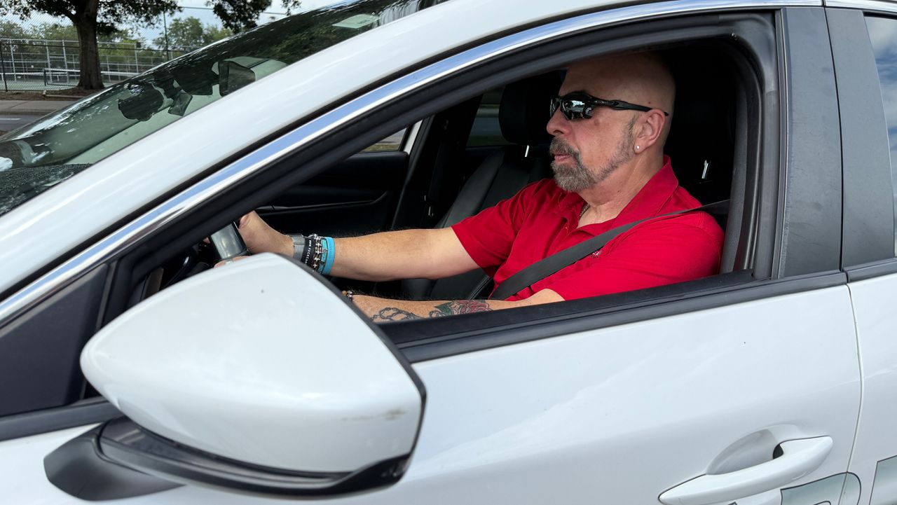 Driving instructor Steve Bowe inside one of the training cars