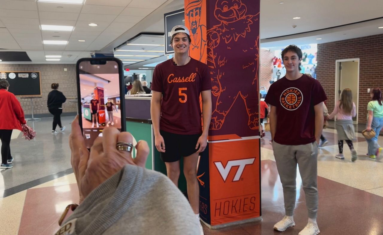 Ethan Chavez (left) posing for a picture at the Women's ACC Tournament.