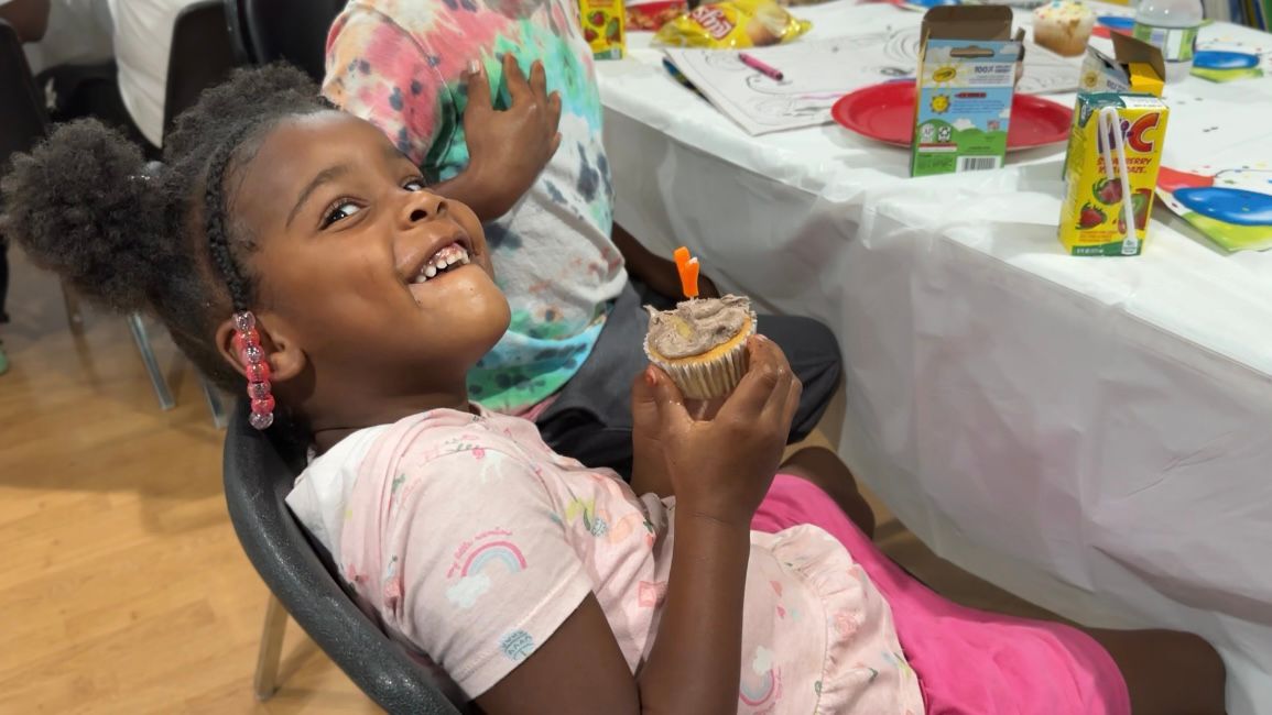 A very happy recipient of a Cake4Kids cupcake. (Spectrum News 1/Rachel Boyd)