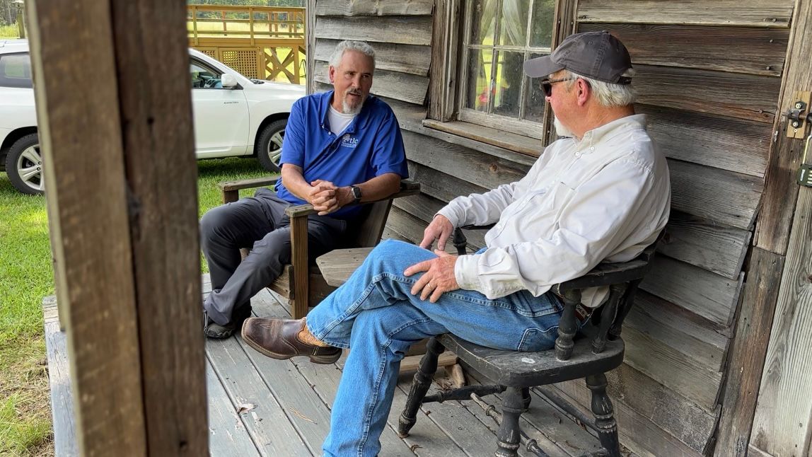 Bo Howes sits with landowner John Narron at his property discussing tax credits. (Spectrum News 1/Rachel Boyd)