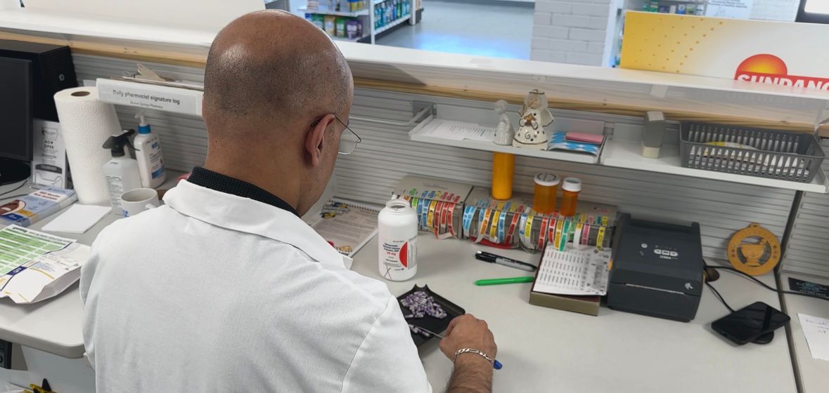 Pharmacist Jacob Abraham sorting pills.