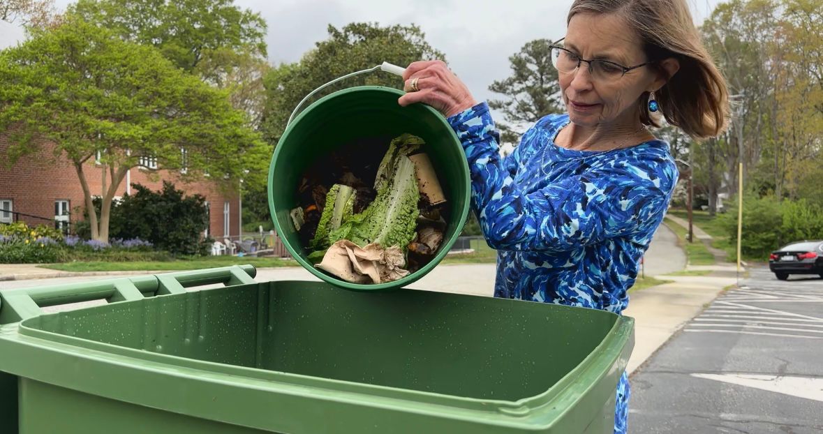 A member of CUCC bringing their compost to be collected.