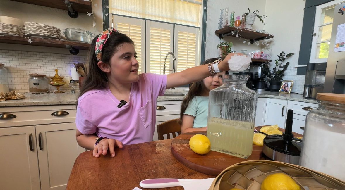 Ava Thompson, 9, makes lemonade with her 6-year-old sister Zoey. The two started a free lemonade stand to raise epilepsy awareness and support for children living with the condition. (Spectrum Bay News 9)
