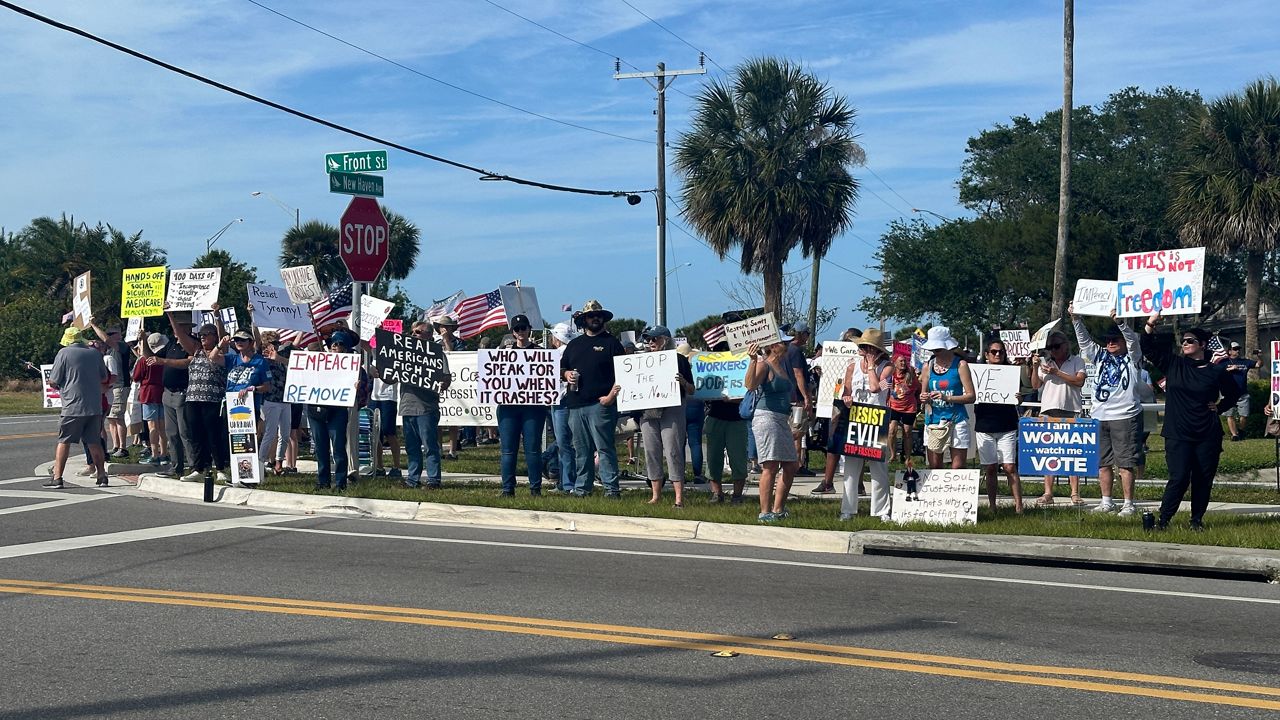 Protestors in Melbourne condemned the Trump administration’s changes that impact federal workers, DEI initiatives, healthcare, veterans and immigrants. (Spectrum News/Massiel Leyva)