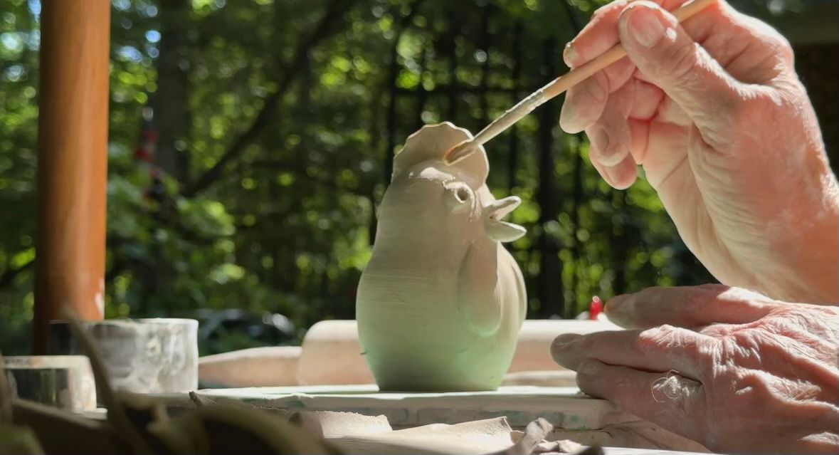 Janet Gaddy working on a crystalline chicken salt and pepper shaker.