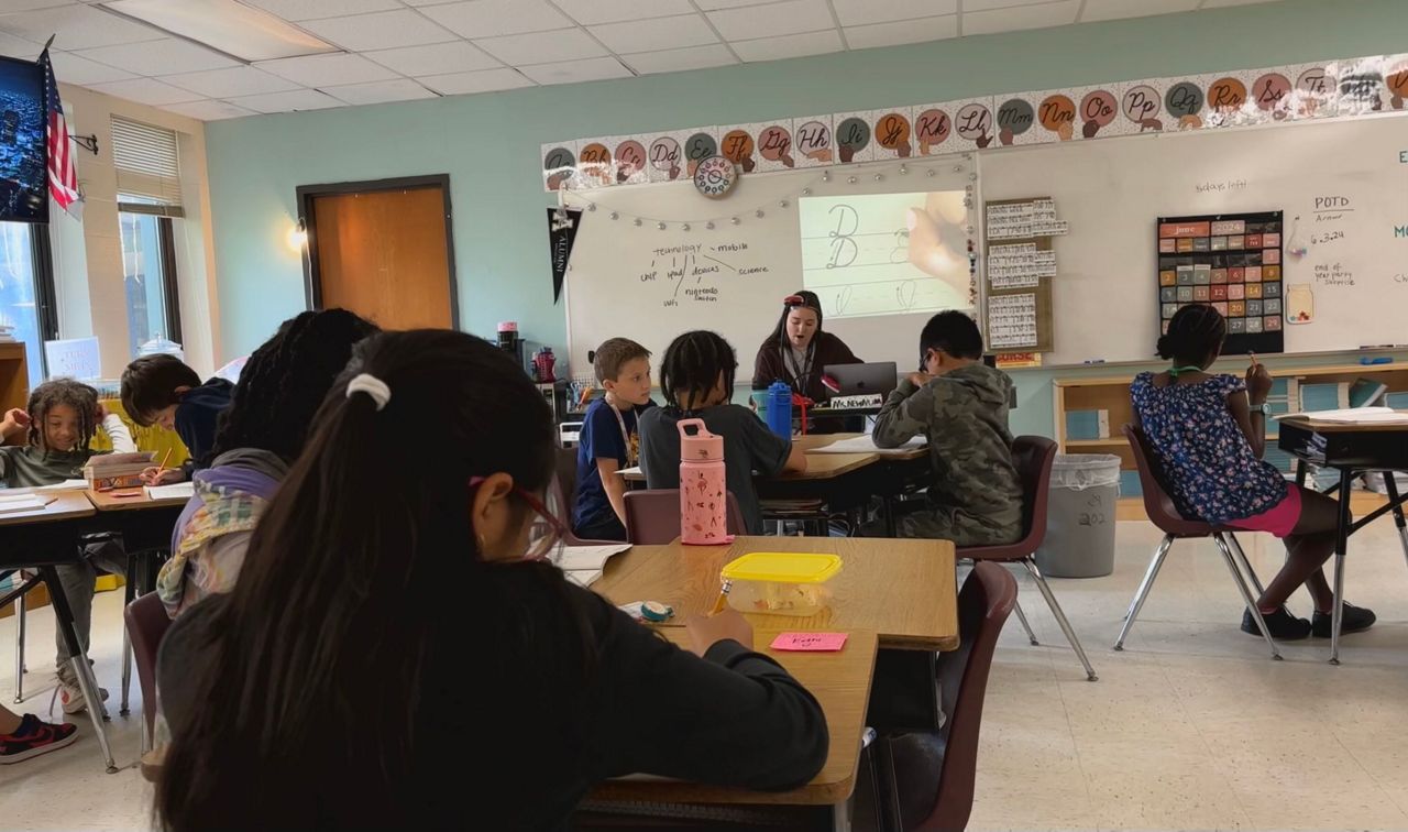 Lydia Newnum leads a lesson on cursive.