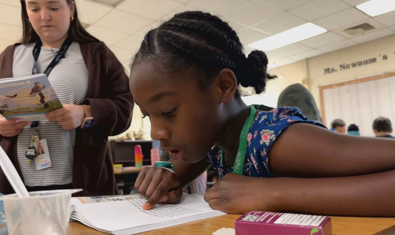 A student in Lydia Newnum's class reading for the class.