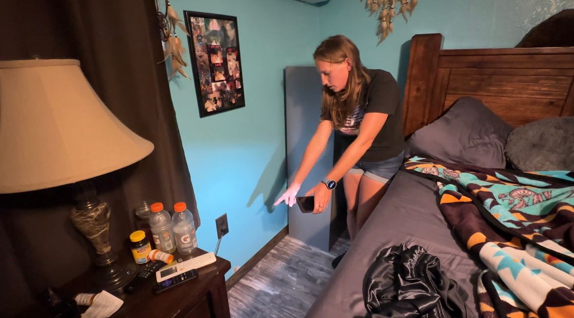 Polk County resident Amanda May shows the water damage to her home after several inches of water threatened homes during a storm on Sunday. (Spectrum News/Alexis Jones)