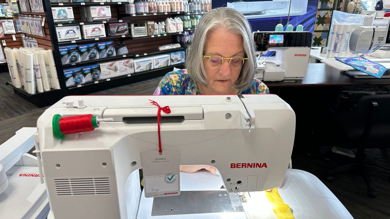 Wendy Kleman, owner of Sew Much More in Waukesha, works at her sewing machine in the shop. 