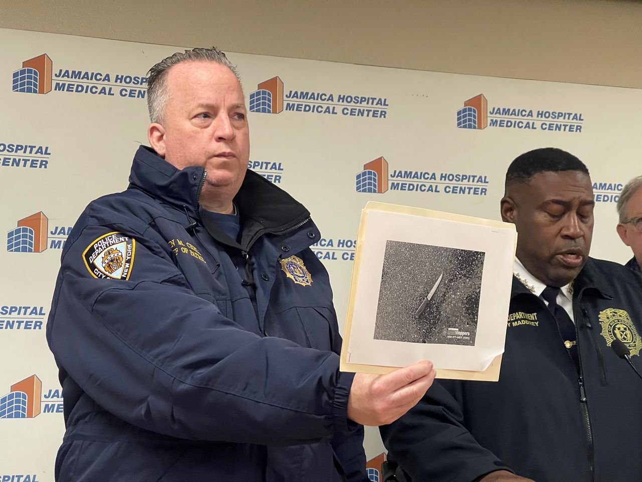 A police officer holds a knife.