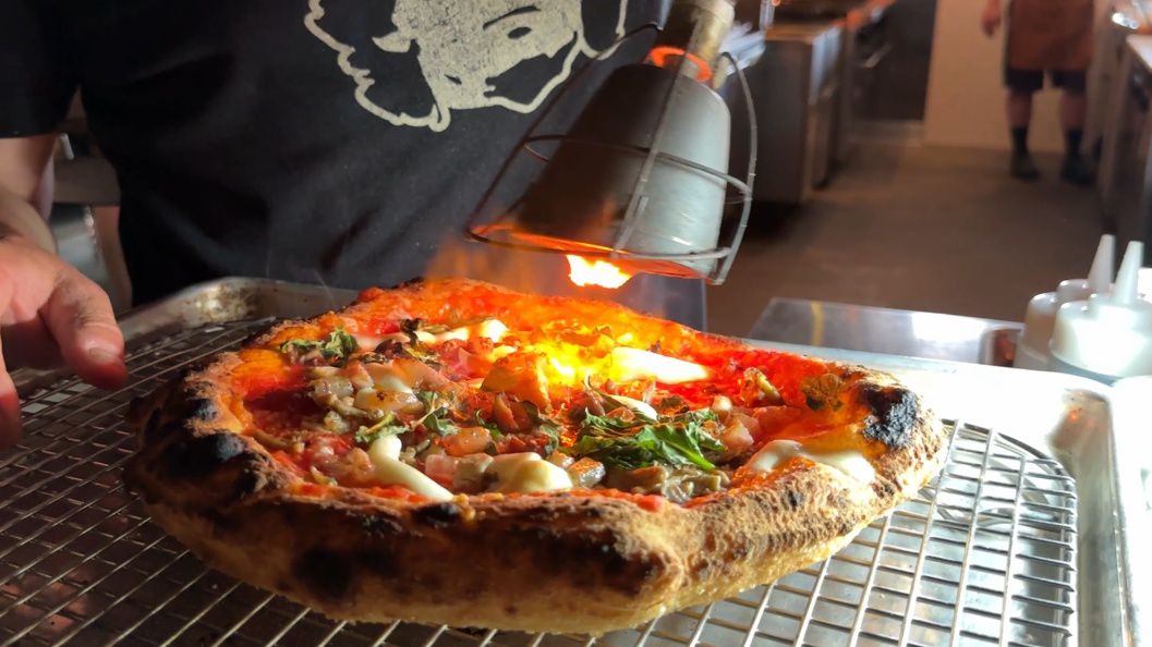 Peyton Smith torches a pizza. 