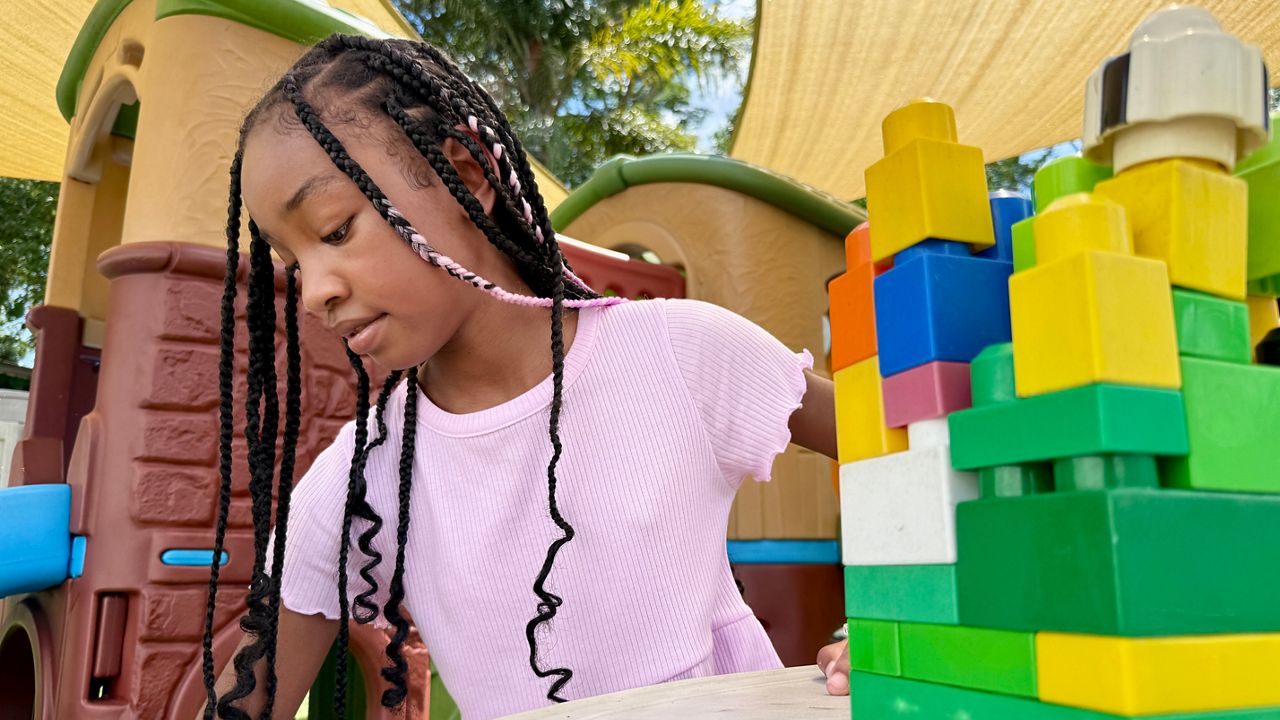 Kids play out back at Kidd's R Us Family Child Care Center in Tampa. Photo Credit: Erin Murray