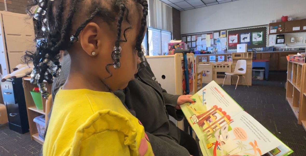 A student reads a book at The Debra Ann November Early Learning Center.