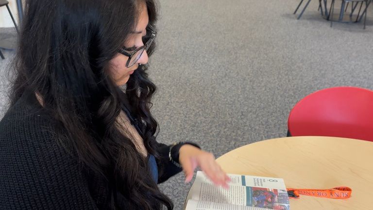 SUNY Orange student Mohua Gazi reads in Shepard Center Photo By: Darcie Ortique