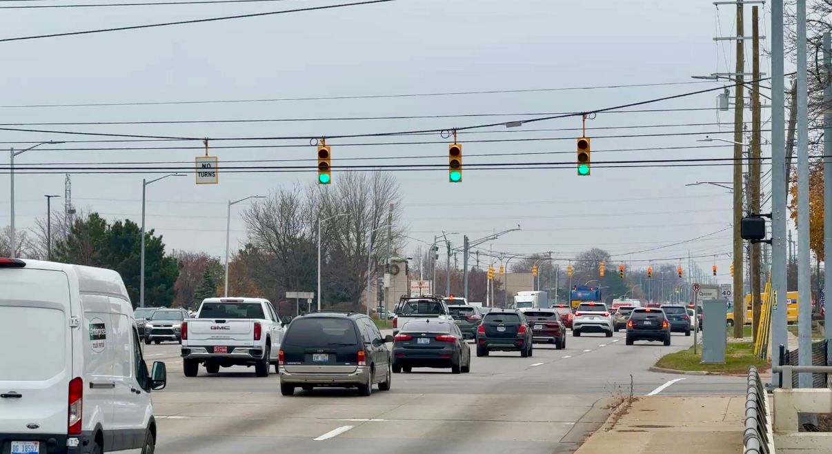 Cars driving in traffic on a busy roadway in Livonia