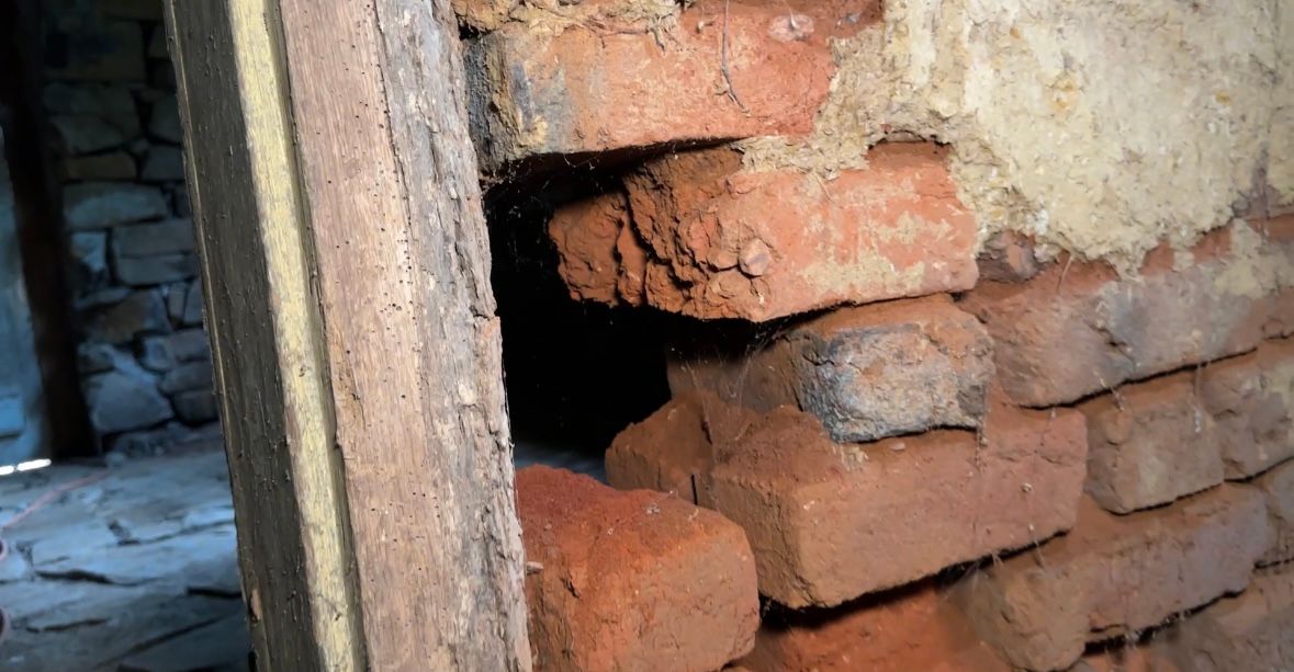 Erosion in the basement of The Potter's House, turning brick to dust.