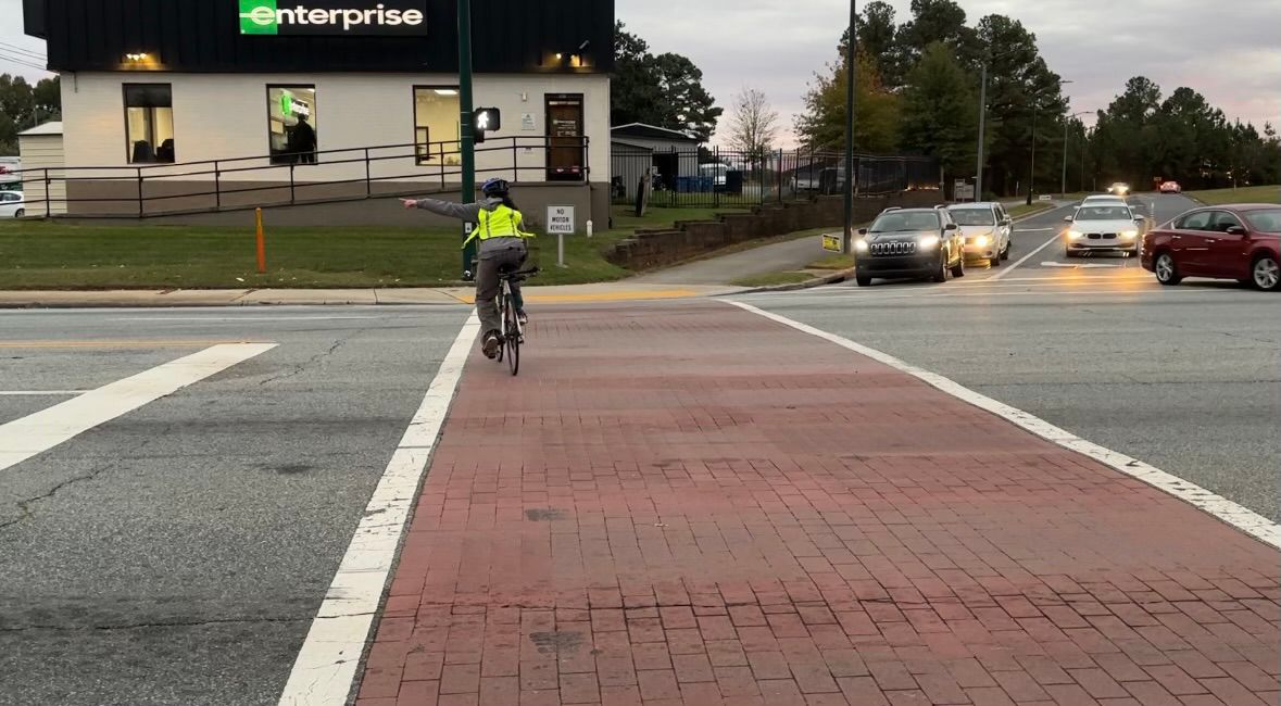 Lindahl signaling a turn on her bike.