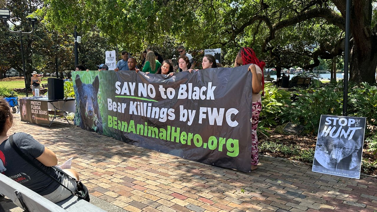 Dozens of animal rights advocated gathered at Lake Eola Park on Sunday to protest a proposed black bear hunt in Florida. (Spectrum News/Philip Peterson)