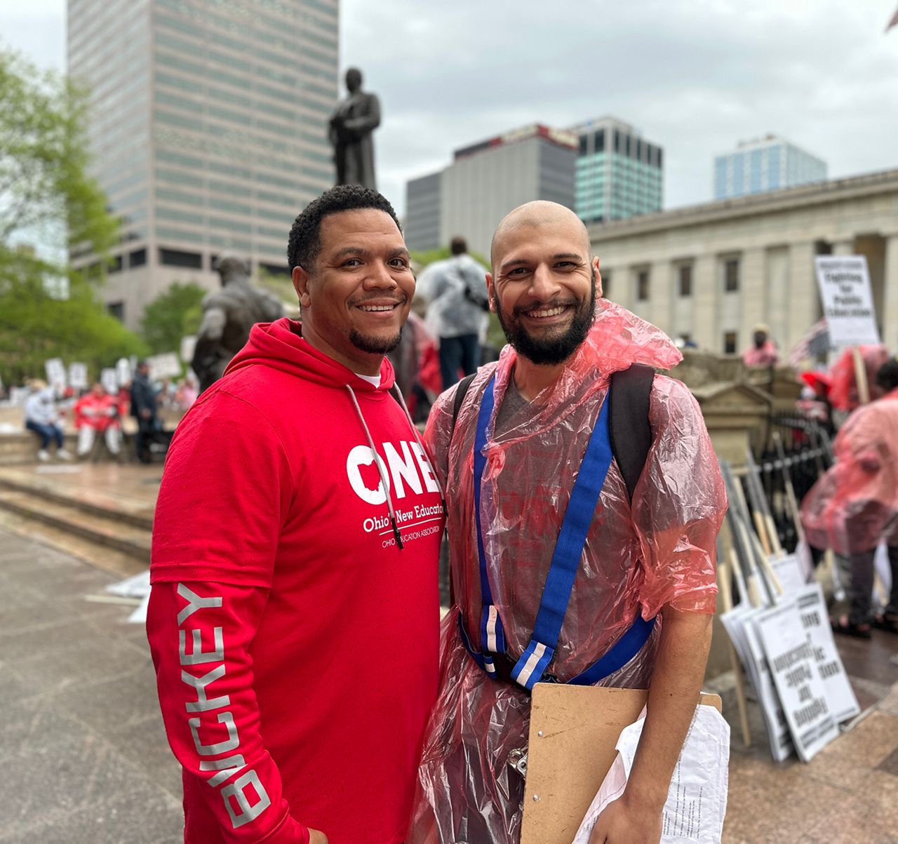 Christopher Monteiro, an English teacher and a member of the Columbus Education Association, stands with another protestor at the Statehouse.