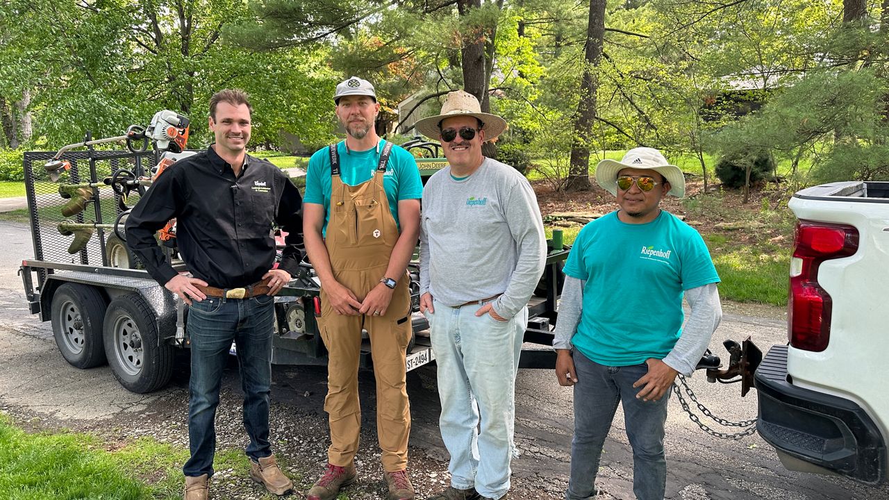 John Riepenhoff, the owner of Riepenhoff Landscape (left) with some of his team, Taylor Bruck/Spectrum News 1