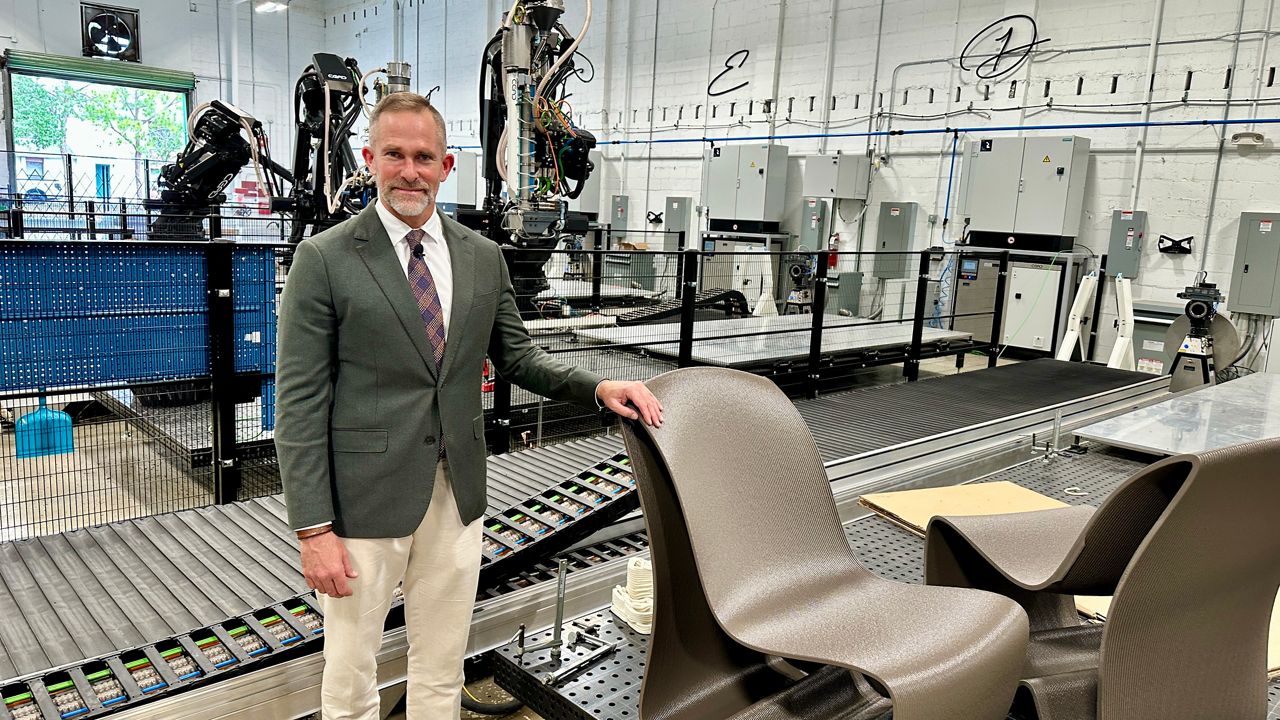 Haddy CEO and Co-Founder Jay Rogers, 51, stands next to a 3D printed chair in the world's largest robot micro-factory in St. Petersburg (photo: Josh Rojas).
