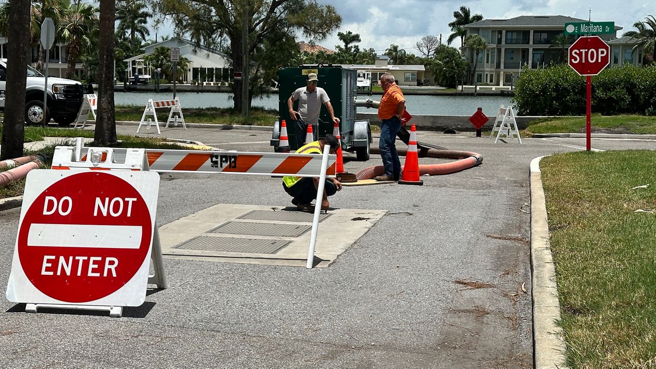 FDOT contractors checked out their access to a damaged backflow preventer on Wednesday in the Don CeSar neighborhood in St. Pete Beach. (Spectrum News/Josh Rojas)