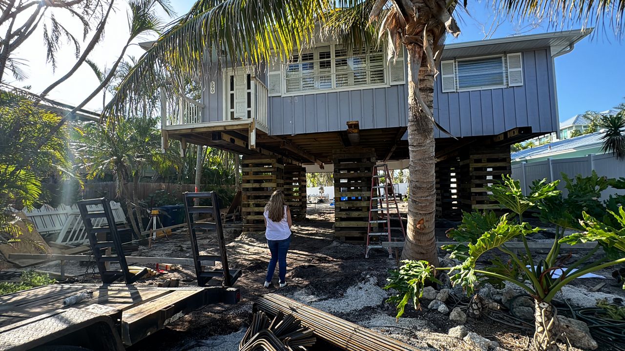 Kellie Day stands in front of her Manatee County home, which is being lifted ahead of the 2025 storm season. (Spectrum Bay News 9/Julia Hazel)