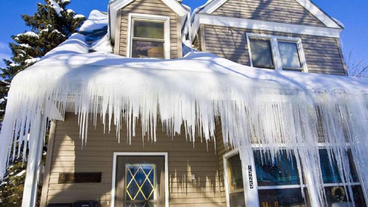 Severe ice dam build-up covering the gutters. 