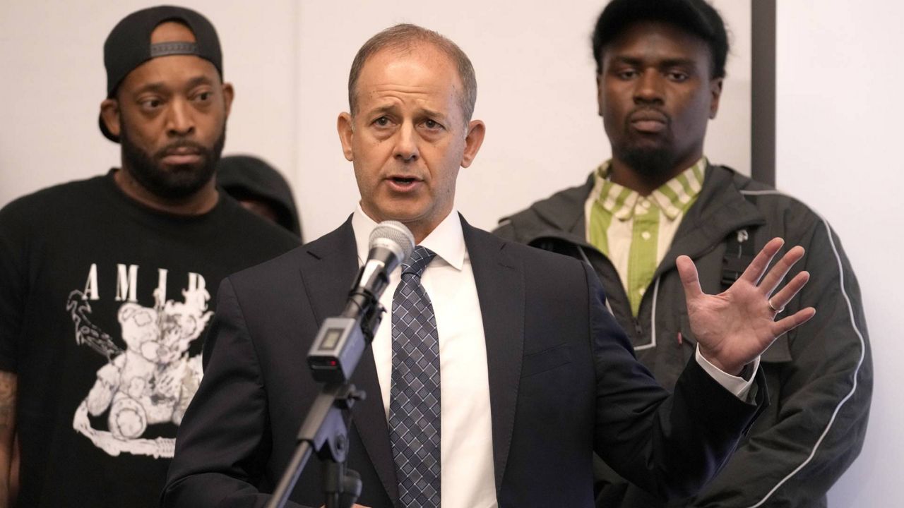 Attorney Jerome Block, center, stands with Donzell, left, and Michael, who allege sexual abuse while in the custody of the Illinois Department of Corrections and Department of Juvenile Justice during a news conference Monday, June 3, 2024, in Chicago. Dozens more former youth inmates filed lawsuits Friday, seeking millions of dollars in damages for sexual abuse they allegedly endured at Illinois detention centers dating back to the late 1990s. (AP Photo/Charles Rex Arbogast)
