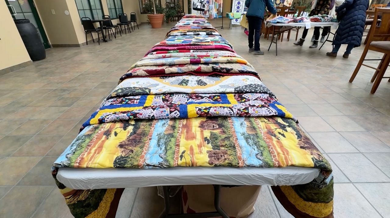 Quilts on a table in a corridor