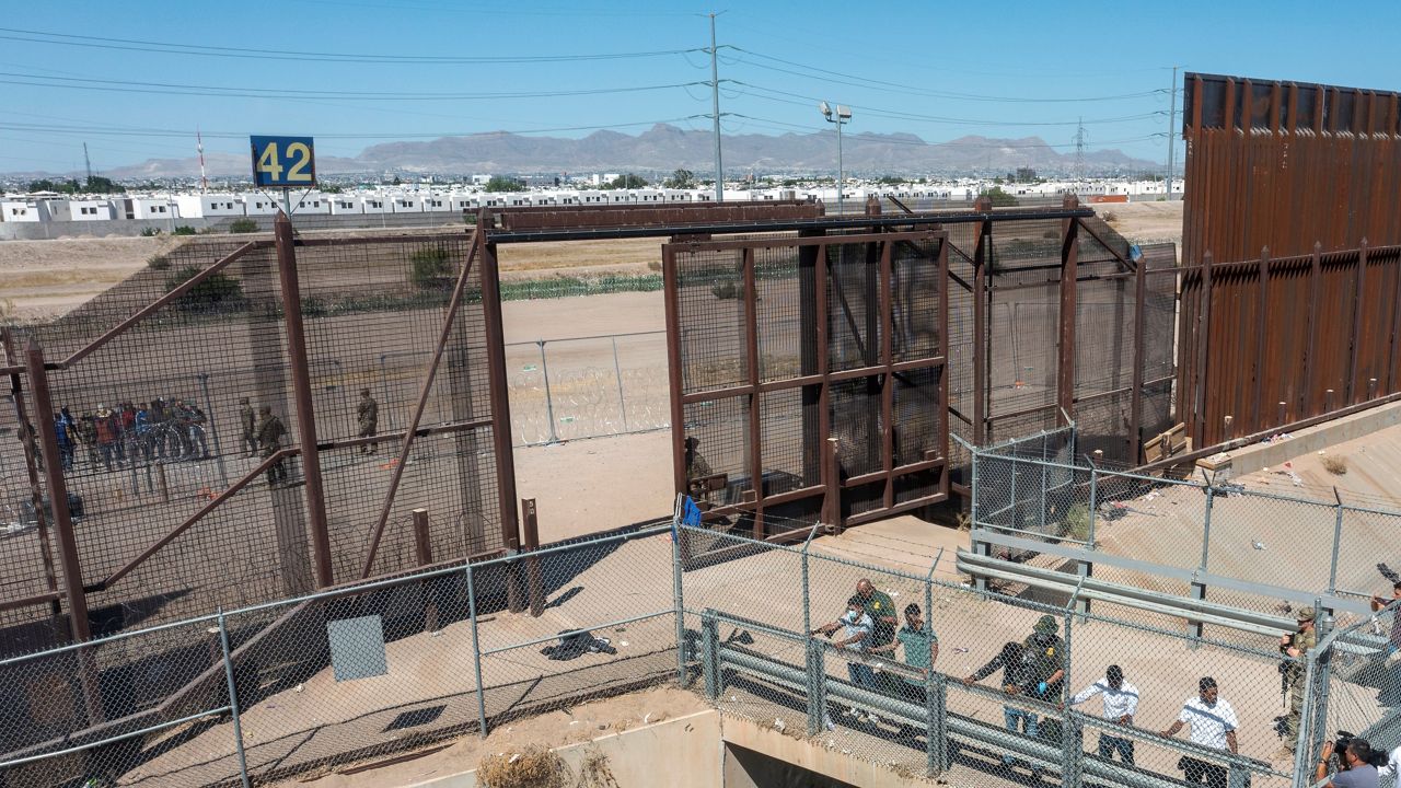 Migrants are pat down by Border Patrol agents before being transported to a processing facility in El Paso, Texas, Wednesday, May 10, 2023. (AP Photo/Andres Leighton)