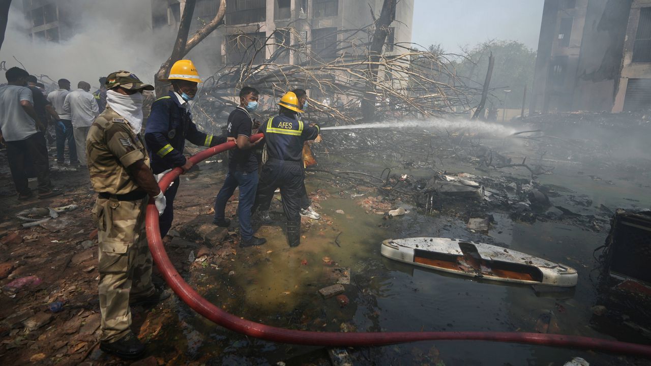 Firefighters work at the site of an airplane that crashed in India's northwestern city of Ahmedabad in Gujarat state, Thursday, June 12, 2025. (AP Photo/Ajit Solanki)