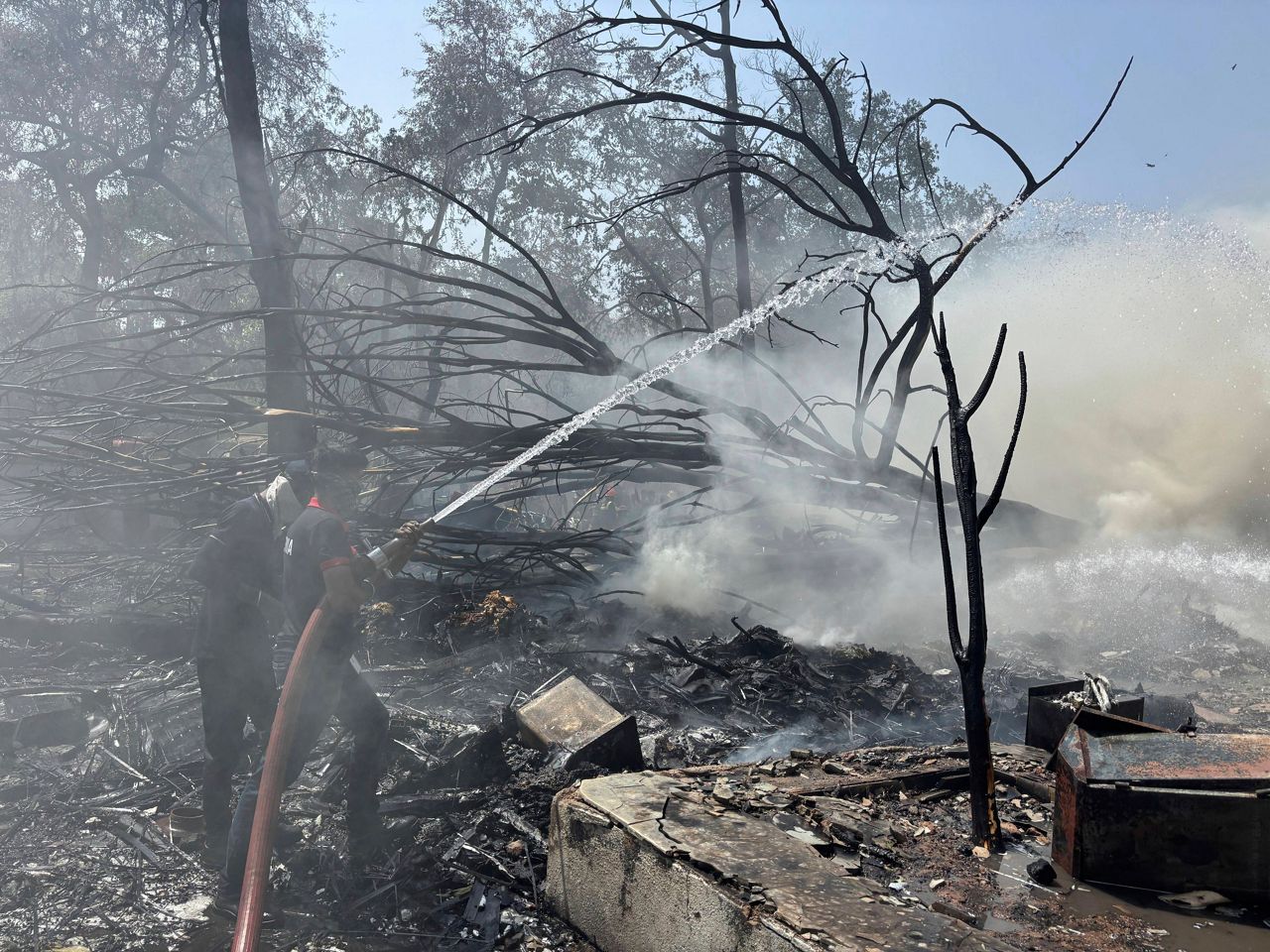 Rescuers work at the site of an airplane that crashed in India's northwestern city of Ahmedabad in Gujarat state, Thursday, June12, 2025. (AP Photo/Ajit Solanki)
