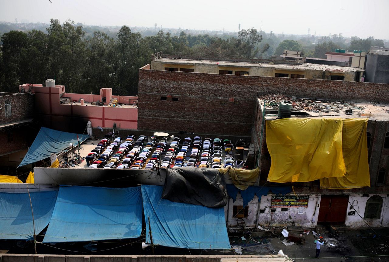 Prayers at fire-bombed mosques as India's riot toll grows