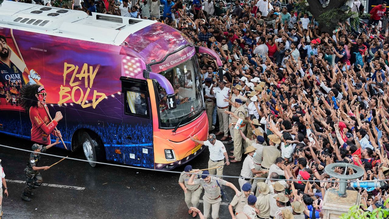 Fans cheer as the bus carrying Royal Challengers Bengaluru cricketers, winners of the Indian Premier League, arrive at the M. Chinnaswamy Stadium in Bengaluru, India, Wednesday, June 4, 2025. (AP Photo/Aijaz Rahi)