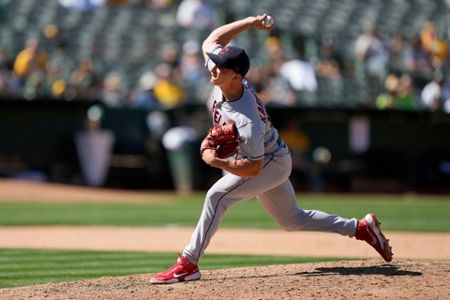 Cleveland Indians relief pitcher James Karinchak air high fives