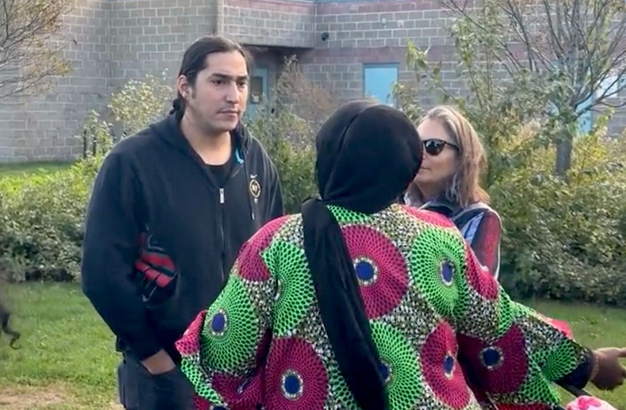 Michael-Corey Hinton, left, a citizen of the Passamaquoddy Tribe and tribal issues attorney at Portland law firm Drummond Woodsum, at the third annual Indigenous People's Day celebration at the Redbank Community Center in South Portland Monday (Spectrum News/Sean Murphy)