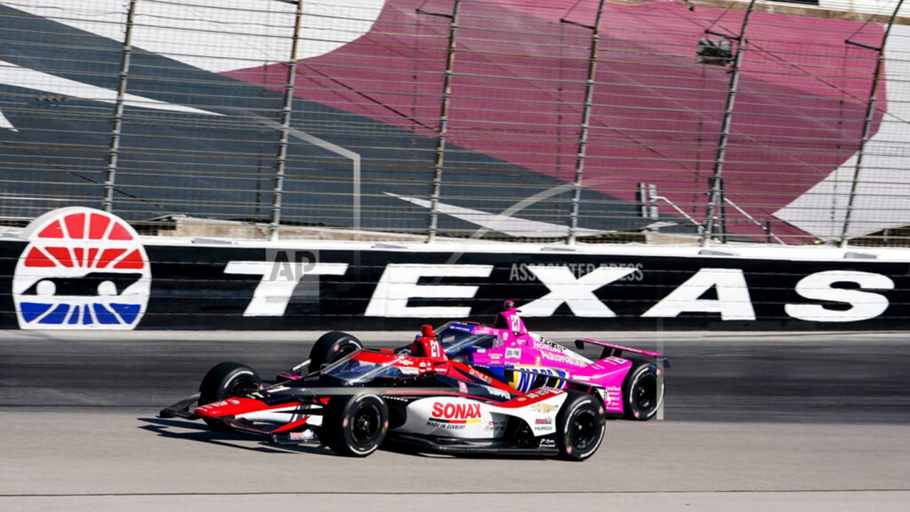 Rinus Veekay passes Alexander Rossi on the fourth turn during the first practice round of the IndyCar Series auto race at Texas Motor Speedway in Fort Worth, Texas on Saturday, March 19, 2022. (AP Photo/Larry Papke)