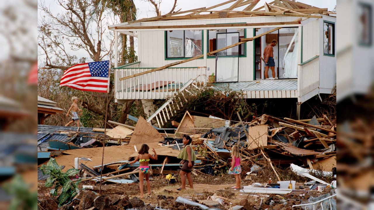 Children play in the rubble left by the fury of Hurricane Iniki, Sept. 15, 1992, at Brennecke's Beach near Poipu Beach, Hawaii, on the island of Kauai. Forecasters say this year's hurricane season for waters around Hawaii will likely be “below-normal” with one to four tropical cyclones across the central Pacific region. (AP Photo/Reed Saxon, File)