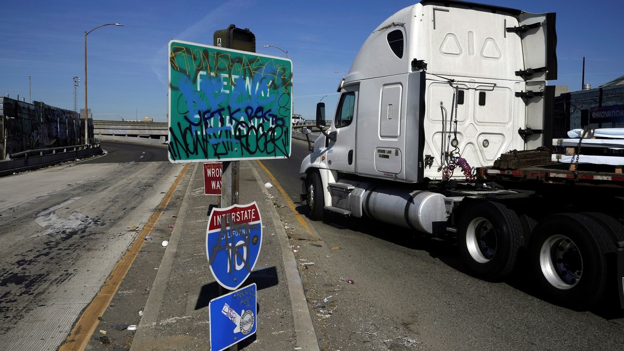 A truck enters a ramp to Interstate 10 in Los Angeles. (AP Photo/Damian Dovarganes)