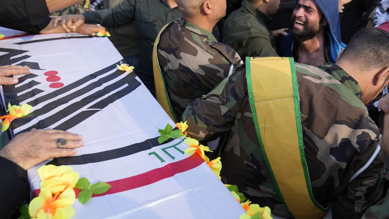 Members of an Iraqi Shiite militant group attend the funeral of a fighter with the Kataib Hezbollah, who was killed in a U.S. airstrike, in Baghdad, Iraq, Thursday, Jan. 25, 2024. (AP Photo/Hadi Mizban)