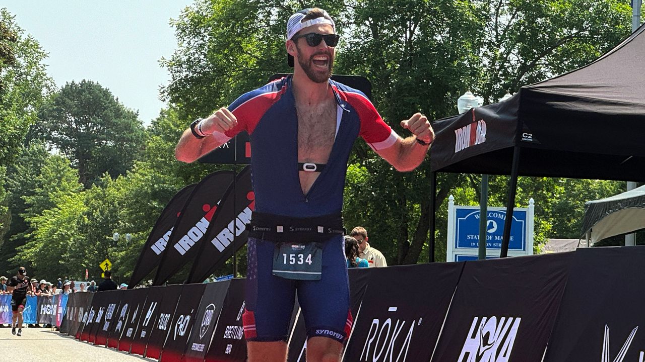 An Ironman participant is fired up as he crosses the finish line. (Spectrum News/Matthew Jaroncyk)