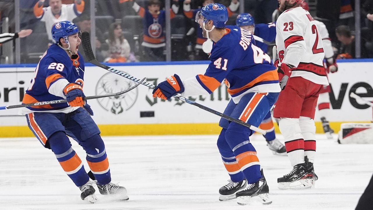 New York Islanders' Alexander Romanov celebrates with Robert Bortuzzo.