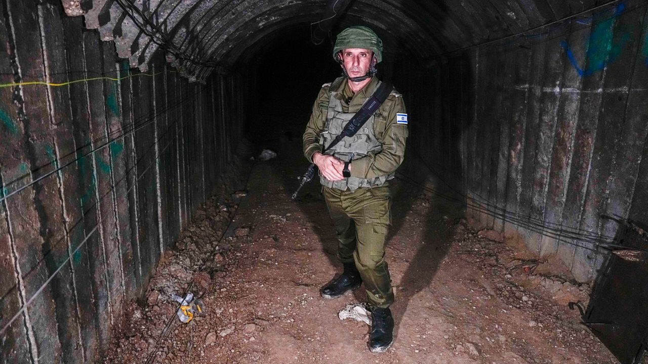 Israeli military spokesperson, Rear Adm. Daniel Hagari, speaks to the media in a tunnel that the military says Hamas militants used to attack the Erez crossing in the northern Gaza Strip, Friday, Dec. 15, 2023. The army is battling Palestinian militants across Gaza to retaliate for Hamas' Oct. 7 attack on Israel. (AP Photo/Ariel Schalit)