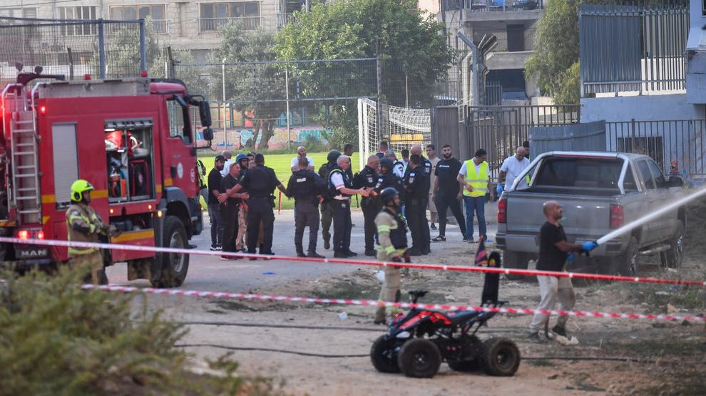 FILE - Israeli police officers and firefighters work at the site of a rocket attack in Majdal Shams, in the Israeli-controlled Golan Heights, Saturday, July 27, 2024. (AP Photo/Gil Eliyahu)