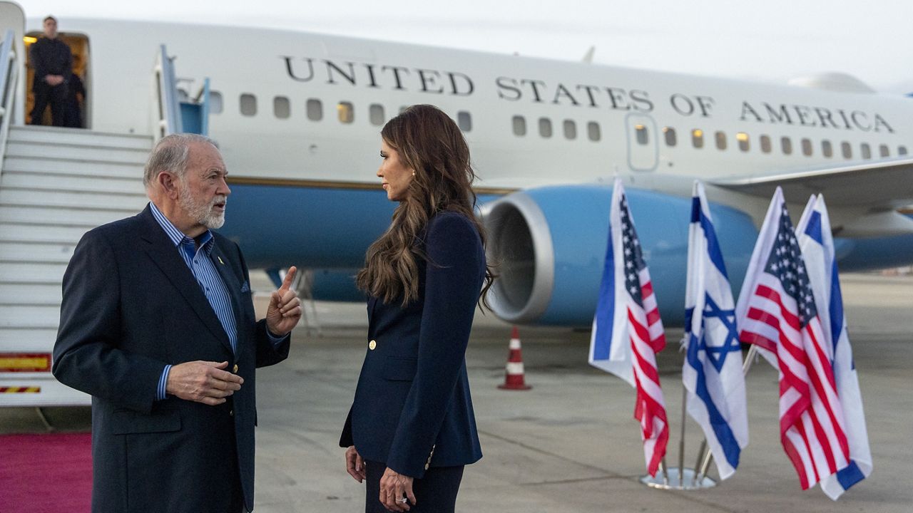 Homeland Security Secretary Kristi Noem speaks with Ambassador Mike Huckabee arrives at Ben Gurion Airport, Sunday, May 25, 2025, Tel Aviv, Israel. (AP Photo/Alex Brandon, Pool)