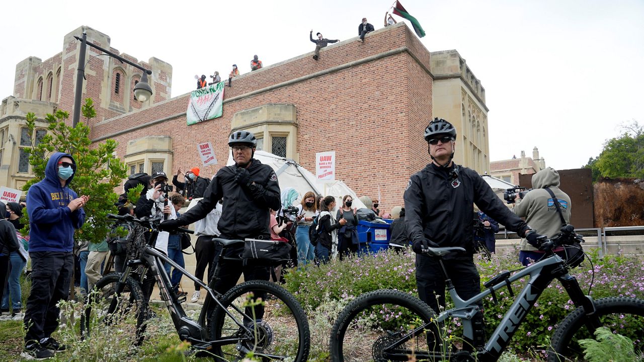 Police set up in near a group of pro-Palestinian demonstrators on the campus of UCLA in Los Angeles on Thursday. (AP Photo/Damian Dovarganes)