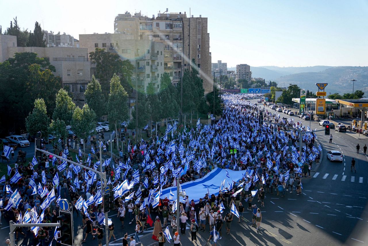 Hundreds of thousands march in Israel. Former security chiefs beg ...