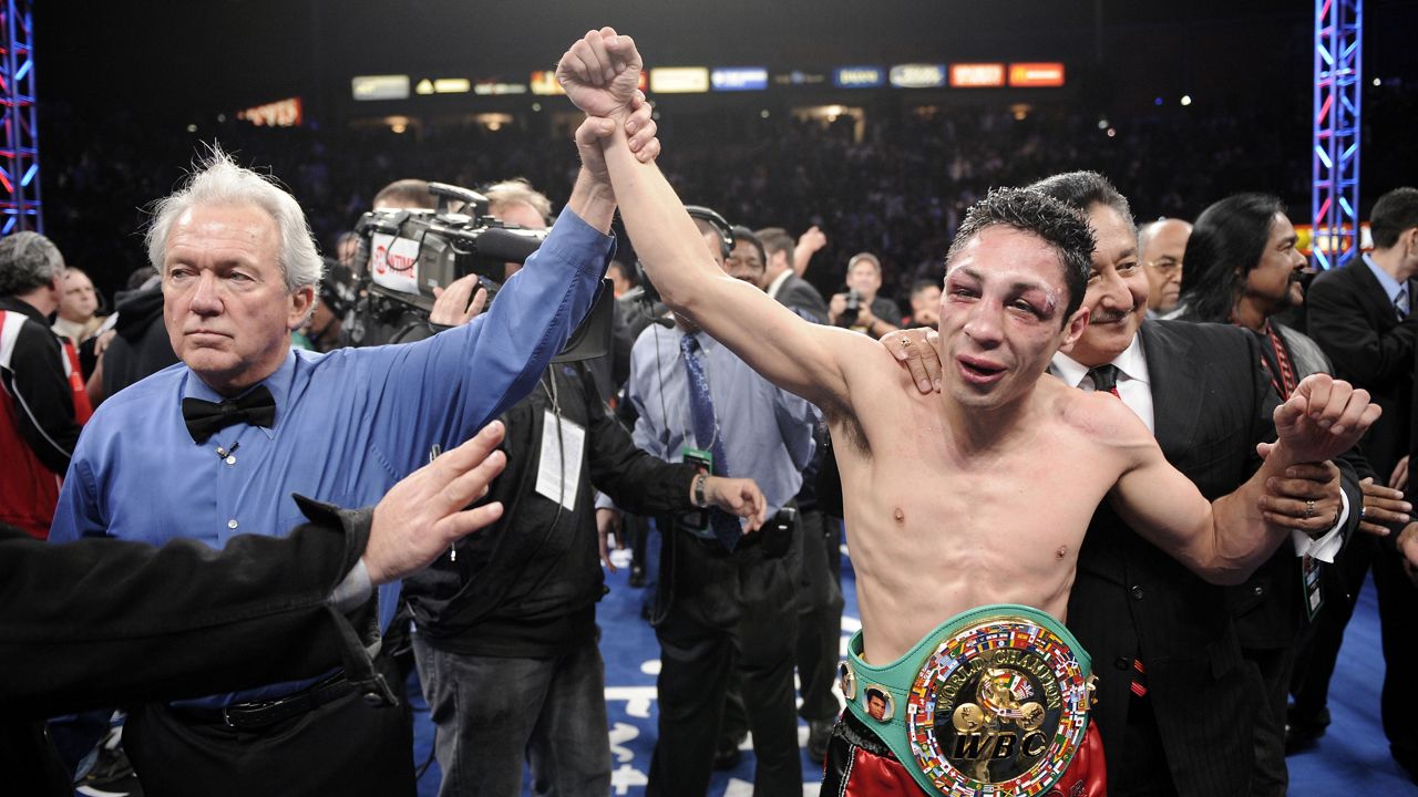 Referee Pat Russell raises the arm of Israel Vázquez of Mexico after he defeated Rafael Marquez of Mexico in their WBC super bantamweight championship bout, in Carson, Calif., March. 1, 2008. (AP Photo/Mark J. Terrill, File)