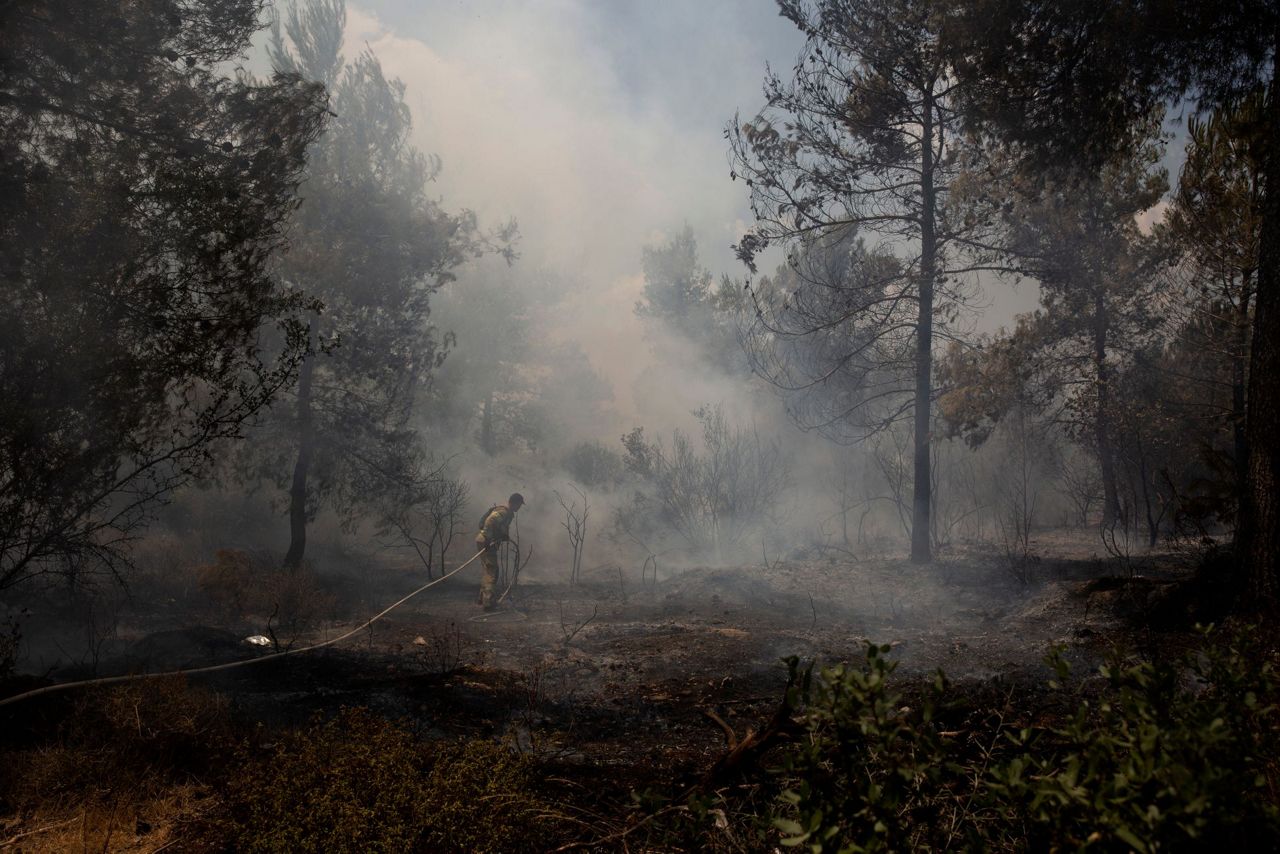 Israeli firefighters work to contain blaze outside Jerusalem
